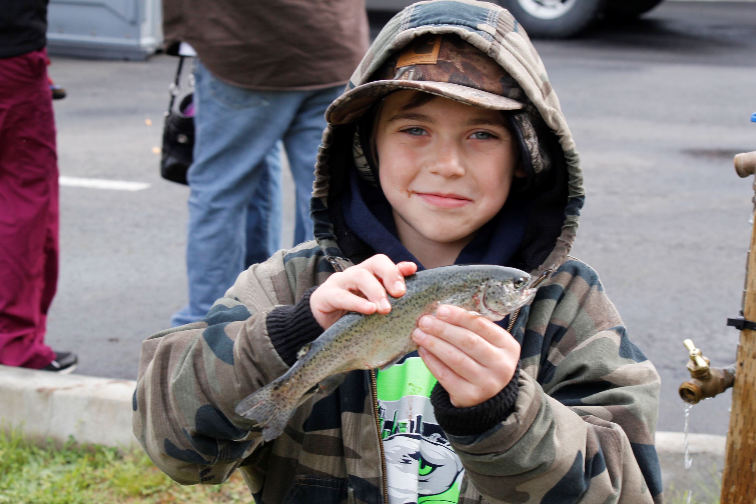 This is a picture of a boy holding a trout he caught during the Annual Kids Trout Derby in Snoqualmi