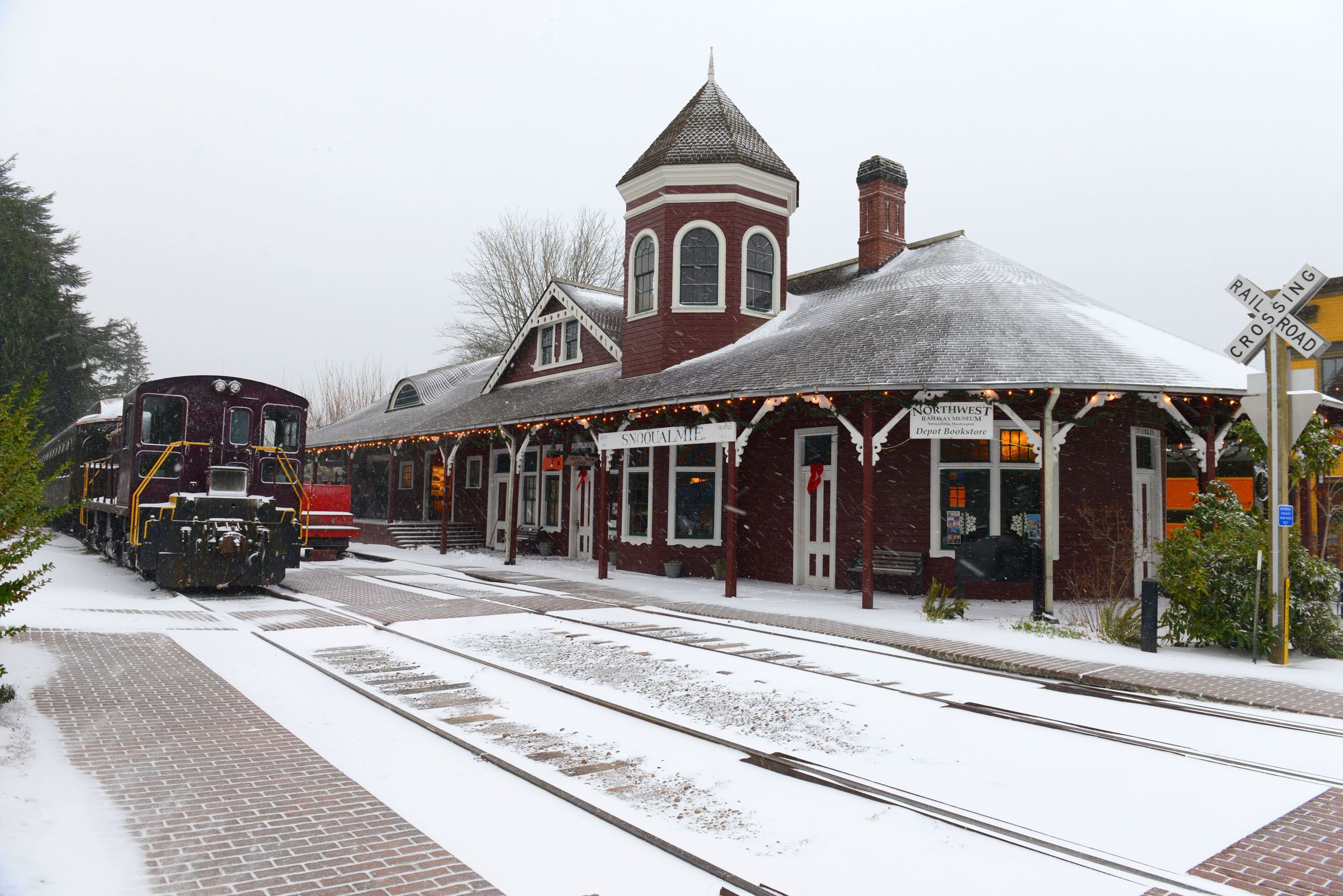 This is a picture of the Historic Snoqualmie Train Depot in the snow.