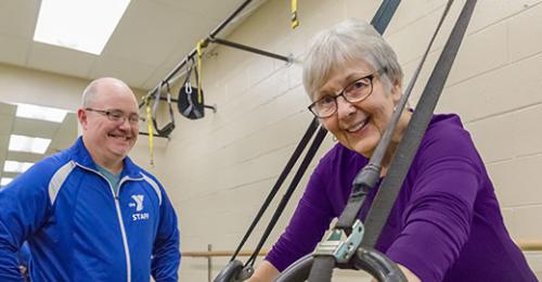 This is a picture of a man and a woman working out at the YMCA.