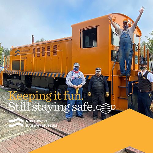 This is a photo of a yellow train that shows people socially distancing due to Covid.